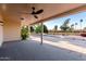 Covered back patio with a ceiling fan and a view of the spacious manicured backyard at 7220 E Edgewood Ave, Mesa, AZ 85208