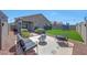 Backyard with a seating area, green grass, string lights and mature landscaping at 7236 W Townley Ave, Peoria, AZ 85345