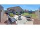 Backyard with a seating area, green grass, string lights and mature landscaping at 7236 W Townley Ave, Peoria, AZ 85345