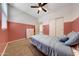 Cozy bedroom featuring carpet, two-tone painted walls, and natural light at 7236 W Townley Ave, Peoria, AZ 85345