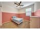 Well-lit bedroom with carpet, ceiling fan and two-tone painted walls at 7236 W Townley Ave, Peoria, AZ 85345