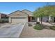 Charming single-story home featuring a two-car garage, desert landscaping, and a vibrant red front door at 7236 W Townley Ave, Peoria, AZ 85345