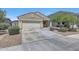 Attractive single-story home featuring a two-car garage, low-maintenance landscaping, and a covered entryway at 7236 W Townley Ave, Peoria, AZ 85345