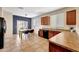 Open kitchen and dining area featuring wood cabinets, tile floors, and a sliding glass door to the backyard at 7236 W Townley Ave, Peoria, AZ 85345