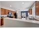 Modern kitchen featuring wood cabinetry, granite countertops, and stainless steel appliances at 7236 W Townley Ave, Peoria, AZ 85345