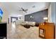 Spacious living room featuring tile flooring, a modern ceiling fan, and stylish decor, ideal for entertaining at 7236 W Townley Ave, Peoria, AZ 85345