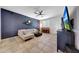 Comfortable living room with a dark accent wall, tile flooring, and a bright window, creating a cozy atmosphere at 7236 W Townley Ave, Peoria, AZ 85345