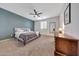 Spacious main bedroom with a ceiling fan, carpet and a serene ambiance at 7236 W Townley Ave, Peoria, AZ 85345