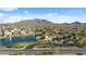 Aerial shot of a beautiful community showcasing a lake, fountain, and views of the surrounding mountains at 7973 S Peppertree Ct, Gilbert, AZ 85298