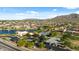 Aerial view showcasing the community amenities, including a lake, fountain, playground, and sparkling pool at 7973 S Peppertree Ct, Gilbert, AZ 85298