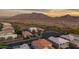 Aerial view of a beautiful neighborhood with desert landscape and stunning mountain views in the distance at 7973 S Peppertree Ct, Gilbert, AZ 85298
