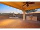 Back patio featuring tile flooring, outdoor kitchen, fireplace, and mountain views at 7973 S Peppertree Ct, Gilbert, AZ 85298