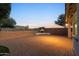 Expansive backyard with brick pavers, fireplace, and desert views provides the perfect outdoor living space at 7973 S Peppertree Ct, Gilbert, AZ 85298