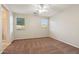 This bedroom offers soft carpet, ceiling fan, and bright windows to let in lots of natural light at 7973 S Peppertree Ct, Gilbert, AZ 85298