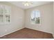 Cozy bedroom with neutral walls, carpet flooring, and an arched window at 7973 S Peppertree Ct, Gilbert, AZ 85298