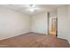 Open bedroom showcasing carpeted floors, ceiling fan, and neutral-toned walls at 7973 S Peppertree Ct, Gilbert, AZ 85298