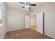 Neutral bedroom with carpeted floor, ceiling fan, and a double door at 7973 S Peppertree Ct, Gilbert, AZ 85298