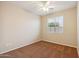 Bedroom with tan walls, ceiling fan, carpeted floor, and window with natural light at 7973 S Peppertree Ct, Gilbert, AZ 85298
