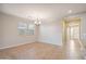 Bright dining area features tile floors, natural light, and a stylish chandelier, perfect for Gathering meals at 7973 S Peppertree Ct, Gilbert, AZ 85298