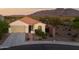 Charming single-story home featuring a terracotta roof, desert landscaping, and mountain views at 7973 S Peppertree Ct, Gilbert, AZ 85298