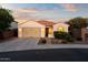Charming single-story home featuring a tile roof, a two-car garage, and a beautifully landscaped front yard at 7973 S Peppertree Ct, Gilbert, AZ 85298