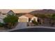 Inviting single-Gathering home featuring desert landscaping, a two-car garage, and picturesque mountain views at 7973 S Peppertree Ct, Gilbert, AZ 85298