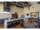 Community kitchen featuring a spacious island with seating, stainless steel appliances, and dining tables at 7973 S Peppertree Ct, Gilbert, AZ 85298