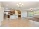 Open-concept living area with tile flooring, stainless steel appliances, granite countertops, and natural lighting at 7973 S Peppertree Ct, Gilbert, AZ 85298