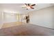 Spacious living area showcasing an open layout with tile and carpet flooring, seamlessly connecting to the kitchen at 7973 S Peppertree Ct, Gilbert, AZ 85298