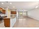 Open-concept living space featuring tile floors, a kitchen island, and sliding glass doors to the backyard at 7973 S Peppertree Ct, Gilbert, AZ 85298