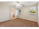 A bright main bedroom showcases an ensuite bath, ceiling fan, and natural light at 7973 S Peppertree Ct, Gilbert, AZ 85298
