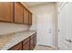 A view of the pantry, showcasing wood cabinets with granite countertops and a neutral color scheme at 7973 S Peppertree Ct, Gilbert, AZ 85298