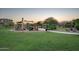 Neighborhood playground at dusk with slides, climbing areas, and lush greenery for a fun outdoor experience at 7973 S Peppertree Ct, Gilbert, AZ 85298