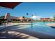Beautiful community pool area with plenty of lounge seating and shade, perfect for relaxing and enjoying the outdoors at 7973 S Peppertree Ct, Gilbert, AZ 85298