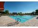Large community pool with lounge chairs, umbrellas, playground and plenty of space for swimming at 7973 S Peppertree Ct, Gilbert, AZ 85298