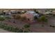 Aerial view of the backyard showcases the covered patio with a desert landscaped perimeter at 7973 S Peppertree Ct, Gilbert, AZ 85298