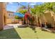 This backyard has a built-in grill and a manicured yard with lush greenery, perfect for relaxing and entertaining at 9132 S Parkside Dr, Tempe, AZ 85284