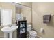 Simple bathroom with pedestal sink and walk-in shower with neutral color palette at 9132 S Parkside Dr, Tempe, AZ 85284