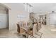 Elegant dining room featuring modern chandelier and glass-top table with seating for eight at 9132 S Parkside Dr, Tempe, AZ 85284