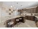 Beautiful kitchen with granite counters, dark cabinets, tile floors, and an eat-in kitchen island at 9132 S Parkside Dr, Tempe, AZ 85284