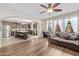 Bright living room featuring hardwood floors, large windows, and open access to kitchen at 9132 S Parkside Dr, Tempe, AZ 85284