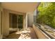 Covered balcony with sliding glass door and view of lush greenery at 945 E Playa Del Norte Dr # 1022, Tempe, AZ 85288