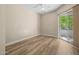 This bedroom features neutral walls, modern flooring, and a sliding glass door at 945 E Playa Del Norte Dr # 1022, Tempe, AZ 85288