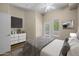 Comfortable bedroom with a TV, dresser, and sliding doors leading to the balcony at 945 E Playa Del Norte Dr # 1022, Tempe, AZ 85288