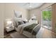 Bright bedroom featuring a sliding glass door, neutral walls, and a ceiling fan at 945 E Playa Del Norte Dr # 1022, Tempe, AZ 85288