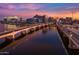 Scenic view of a bridge spanning a serene body of water with city buildings in the background at 945 E Playa Del Norte Dr # 1022, Tempe, AZ 85288