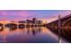 Picturesque bridge reflected in calm waters, with a colorful sunset sky and city skyline at 945 E Playa Del Norte Dr # 1022, Tempe, AZ 85288