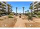 Beautifully landscaped common area featuring a brick pathway, garden, and inviting seating areas at 945 E Playa Del Norte Dr # 1022, Tempe, AZ 85288