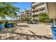 Serene courtyard featuring mature trees, blue pots and building exteriors at 945 E Playa Del Norte Dr # 1022, Tempe, AZ 85288