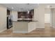 Open-concept kitchen features dark wood cabinetry, granite countertops, and stainless steel appliances at 945 E Playa Del Norte Dr # 1022, Tempe, AZ 85288